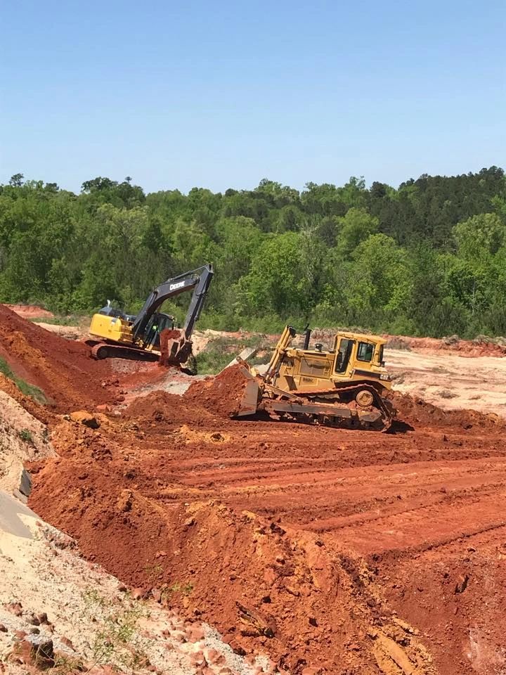Heavy earthmoving equipment on red clay
