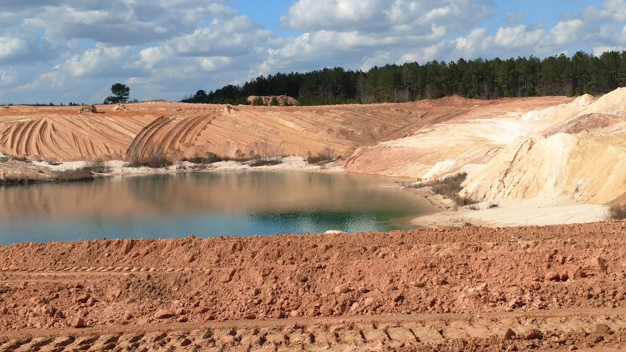 Quarry mining excavation with water pond